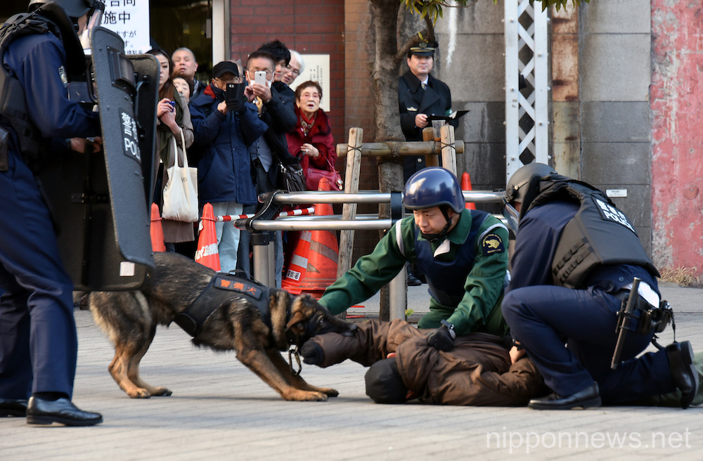 Armed police conduct mock security drill at Shinbashi station in Tokyo