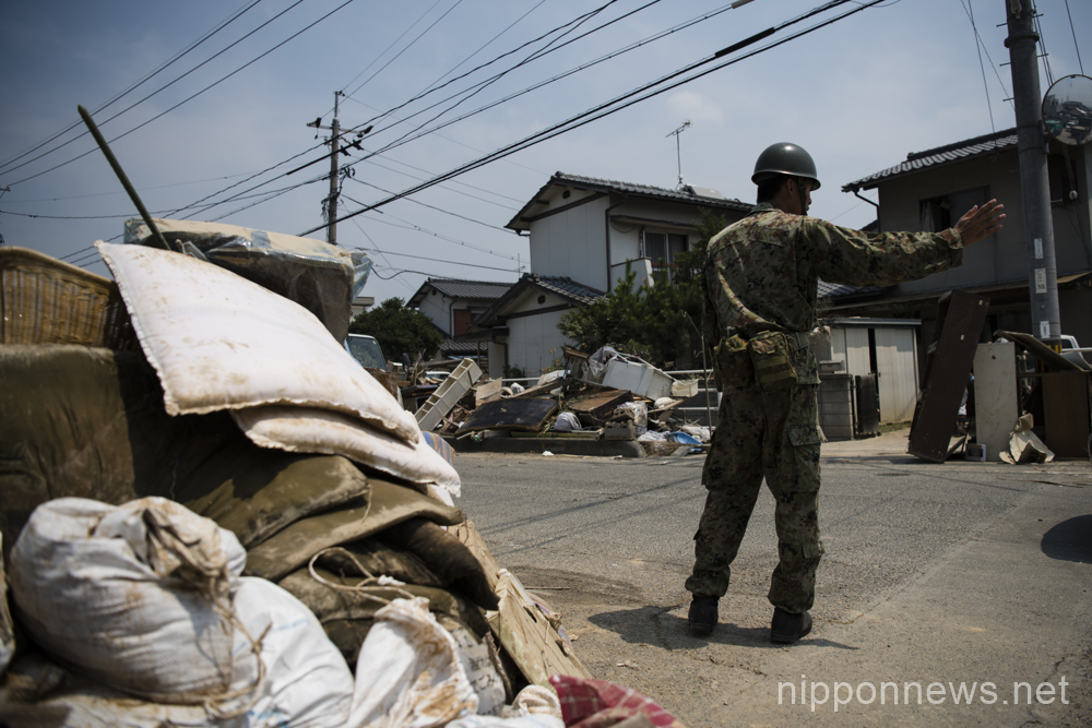 Cleaning and recovery efforts continue in heat after flood disaster in Okayama