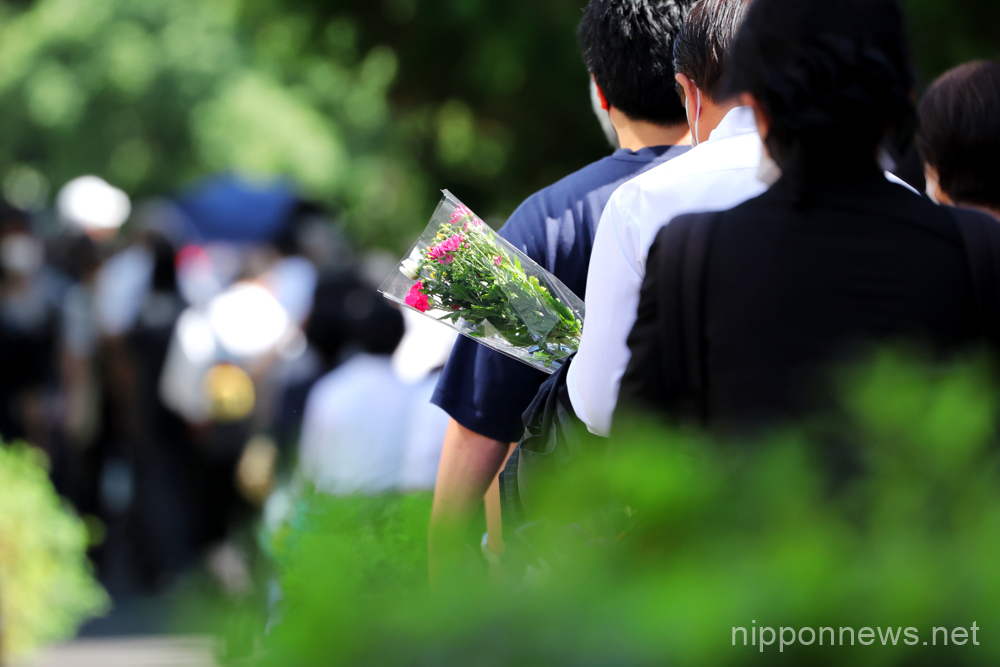 People line up near the Nippon Budokan to offer flowers ahead of the state funeral for Japan's former Prime Minister Shinzo Abe in Tokyo, Japan on September 27, 2022. (Photo by Naoki Nishimura/AFLO)