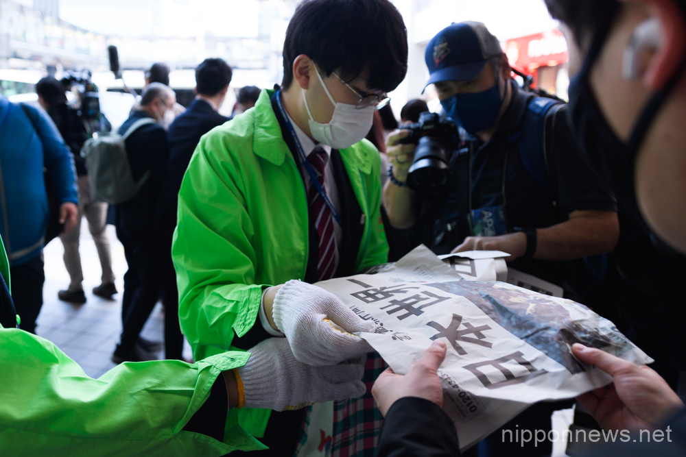A newspaper worker hands out a special edition version of the Yomiuri Newspaper celebrating Team Japan's victory in the 2023 World Baseball Classic final on March 22, 2023, in the Shibuya district of Tokyo, Japan. Japan defeated team USA 3-2 in the tournament final held in Miami to record their third championship title.(Photo by Keiichi Miyashita/AFLO)