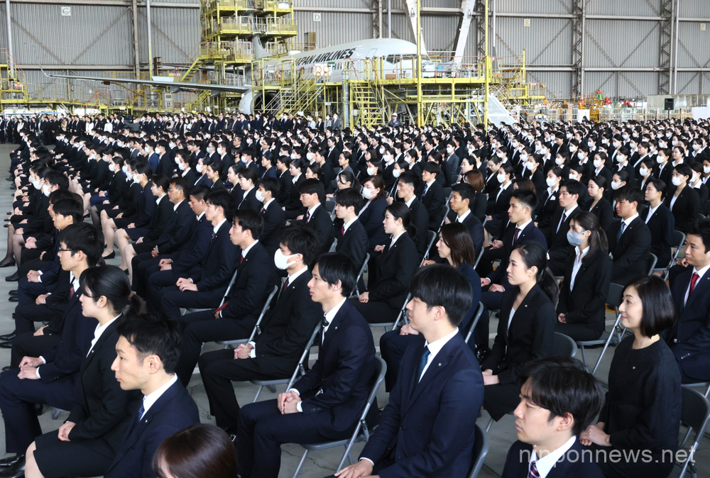 April 3, 2023, Tokyo, Japan - Newly hired Japan Airlines (JAL) employees listen to president Yuji Akasaka's speech at JAL's entrance ceremony at a JAL hangar of Haneda Airport in Tokyo on Monday, April 3, 2023. JAL group hired 2,000 new employees this year. (photo by Yoshio Tsunoda/AFLO)