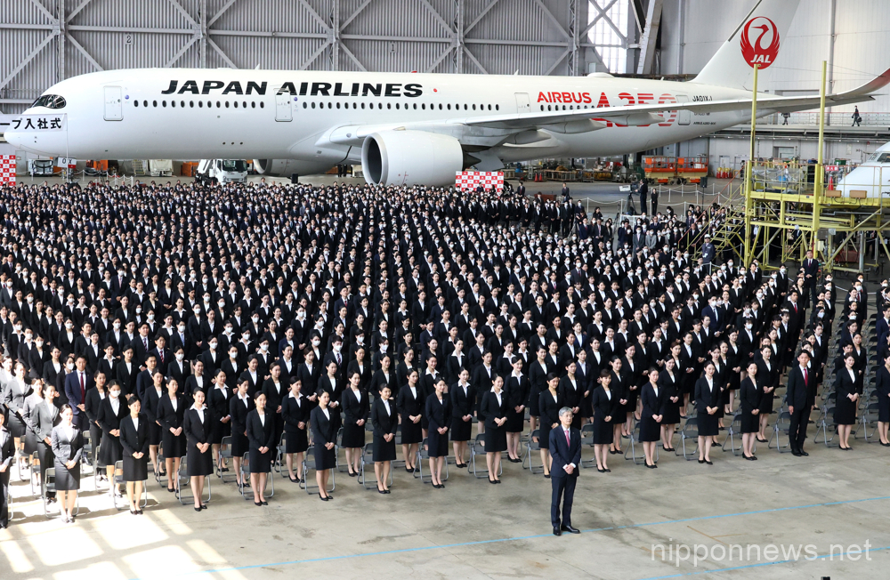 April 3, 2023, Tokyo, Japan - Japan Airlines (JAL) president Yuji Akasaka (C) and newly hired employees fly their paper planes at JAL's entrance ceremony at a JAL hangar of Haneda Airport in Tokyo on Monday, April 3, 2023. JAL group hired 2,000 new employees this year. (photo by Yoshio Tsunoda/AFLO)