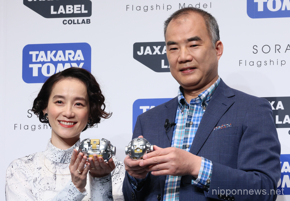 April 13, 2023, Tokyo, Japan - Former Japanese astronaut Soichi Noguchi (R) and artist Tomoe Shinohara (L) display "Sora-Q Flagship Model" produced by Japanese toy maker Tomy, real-scale sized toy of a transformed moon probe "Sora-Q" at a presentation in Tokyo on Thursday, April 13, 2023. Japan Aerospace Exploration Agency (JAXA), Sony, Doshisha University and Tomy developed the baseball sized moon probe "Sora-Q" which will be prove surface of the moon and transmit pictures to the earth. (photo by Yoshio Tsunoda/AFLO)