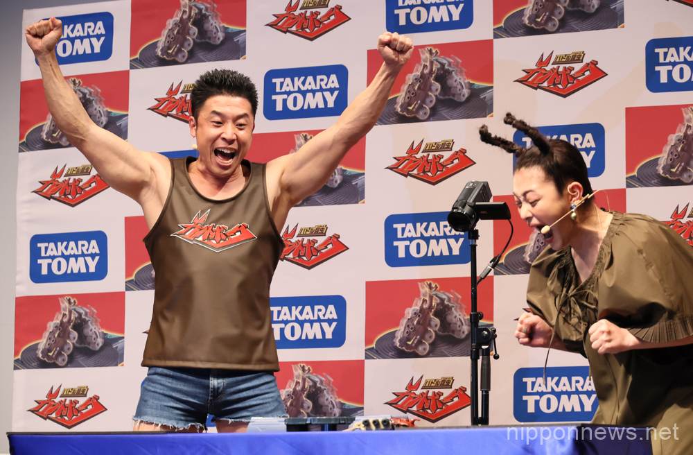 April 19, 2023, Tokyo, Japan - Japanese bodybuilder and actor Nakayama Kinnikun (L) and actress Sakura Inoue (R) play Japanese toy maker Tomy's new battle insect toy "Kabuto Borg" at a promotional event in Tokyo on Wednesday, April 19, 2023. Kabuto Borg is fight game on a board with two beetle shaped toys. (photo by Yoshio Tsunoda/AFLO)