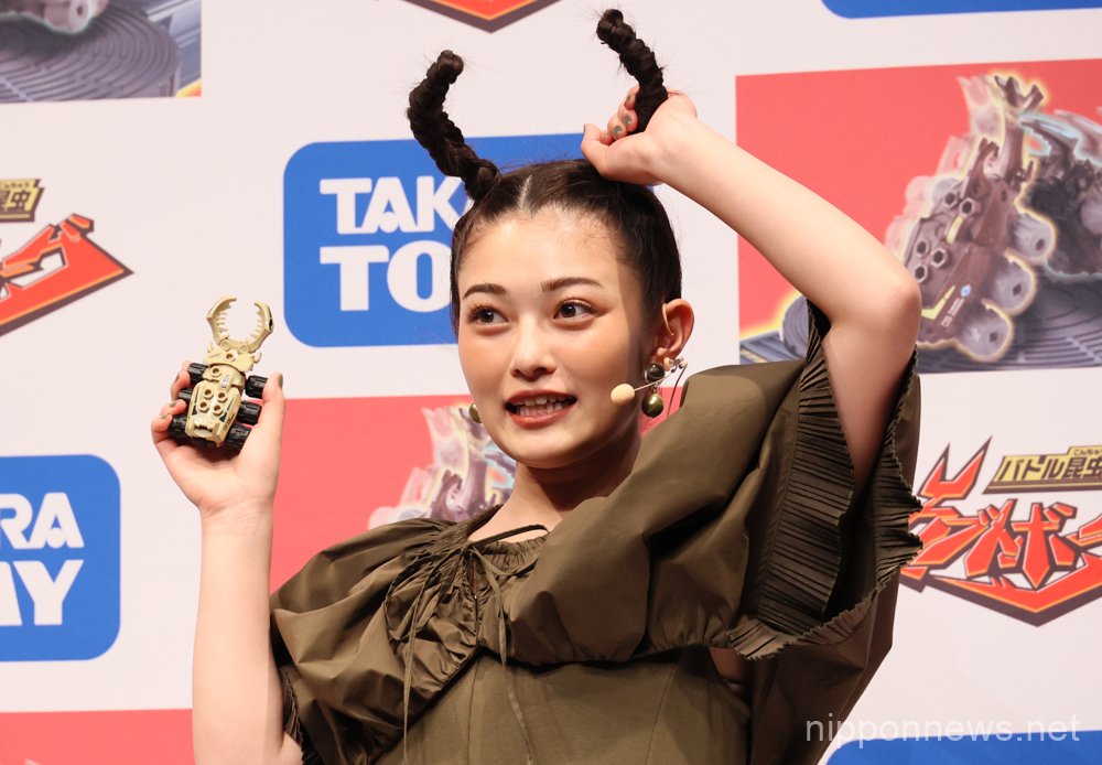 April 19, 2023, Tokyo, Japan - Japanese actress Sakura Inoue displayx Japanese toy maker Tomy's new battle insect toy "Kabuto Borg" at a promotional event in Tokyo on Wednesday, April 19, 2023. Kabuto Borg is fight game on a board with two beetle shaped toys. (photo by Yoshio Tsunoda/AFLO)