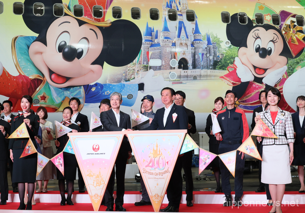 June 9, 2023, Tokyo, Japan - Japan Airlines (JAL) president Yuji Akasaka (C, L) and Tokyo Disney Resort operator Oriental Land president Kenji Yoshida (C, R) with their employees display the "JAL Colorful Dreams Express" jetliner to celebrate the Disneyland's 40th anniversary at a JAL hangar at the Haneda airport in Tokyo on Friday, June 9, 2023. The new Disney characters designed Boeing 767 launched JAL's domestic routes. (photo by Yoshio Tsunoda/AFLO)